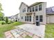 A beautiful backyard features a concrete patio with brick trim and a barbecue grill near the home's exterior at 10125 Loch Lomond Dr, Charlotte, NC 28278