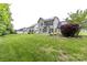 Spacious backyard featuring a well-maintained lawn and a view of the home's exterior at 10125 Loch Lomond Dr, Charlotte, NC 28278