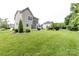Lush backyard with green grass, mature trees, and manicured landscaping at 10125 Loch Lomond Dr, Charlotte, NC 28278