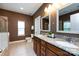 A bathroom with a granite countertop with double sinks and matching framed mirrors at 10125 Loch Lomond Dr, Charlotte, NC 28278