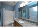 Modern bathroom features granite countertop, wood cabinets, and shower-tub combination at 10125 Loch Lomond Dr, Charlotte, NC 28278