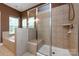 A bathroom with a separate shower with tiled walls and a built-in bench at 10125 Loch Lomond Dr, Charlotte, NC 28278