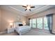 A bedroom with a tray ceiling, carpet, and three windows for ample sunlight at 10125 Loch Lomond Dr, Charlotte, NC 28278