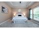 A bedroom with a tray ceiling, carpet, and two windows for ample sunlight at 10125 Loch Lomond Dr, Charlotte, NC 28278