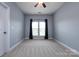 Bedroom with neutral colors, natural light, ceiling fan, and closet at 10125 Loch Lomond Dr, Charlotte, NC 28278