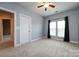 Bedroom with neutral colors, natural light, ceiling fan, and closet at 10125 Loch Lomond Dr, Charlotte, NC 28278