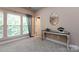Bonus room with carpet and bright windows, with an adjacent doorway to the attic at 10125 Loch Lomond Dr, Charlotte, NC 28278