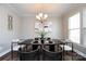 The dining room has a modern chandelier, art, and a table set for four at 10125 Loch Lomond Dr, Charlotte, NC 28278