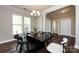 Dining room features a modern chandelier, crown molding, and large windows at 10125 Loch Lomond Dr, Charlotte, NC 28278