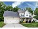 Charming two-story home with a well-maintained lawn and a two car garage at 10125 Loch Lomond Dr, Charlotte, NC 28278