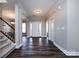 Open foyer with hardwood floors, staircase, and neutral walls at 10125 Loch Lomond Dr, Charlotte, NC 28278