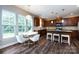 Open kitchen and dining area boasts wood floors, stainless appliances, and ample counter space at 10125 Loch Lomond Dr, Charlotte, NC 28278