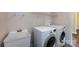 Functional laundry room equipped with washer, dryer, and utility sink at 10125 Loch Lomond Dr, Charlotte, NC 28278