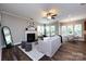 Bright living room with a fireplace, a ceiling fan, and a decorative rug at 10125 Loch Lomond Dr, Charlotte, NC 28278