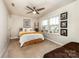 Bright bedroom with a ceiling fan, natural light, and views of the neighborhood at 1090 River Haven Sw Ave # 61, Concord, NC 28025