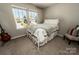 Cozy bedroom with a white bed frame, natural light from windows, and neutral decor at 1090 River Haven Sw Ave # 61, Concord, NC 28025