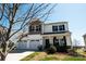 Attractive home featuring a two-car garage, covered porch, and mature landscaping at 1090 River Haven Sw Ave # 61, Concord, NC 28025