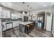 Open concept kitchen with white cabinetry, island with seating, and stainless steel dishwasher at 1090 River Haven Sw Ave # 61, Concord, NC 28025