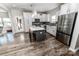 Bright kitchen featuring a large island, stainless steel appliances, and wood flooring at 1090 River Haven Sw Ave # 61, Concord, NC 28025