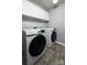 Bright laundry room featuring modern Samsung washer and dryer with storage cabinets at 1090 River Haven Sw Ave # 61, Concord, NC 28025