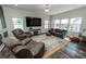 Comfortable living room with large windows, plush chairs, and decorative area rug at 1090 River Haven Sw Ave # 61, Concord, NC 28025