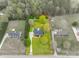 A serene aerial view of the home's lot, bordered in red, with lush greenery and mature trees at 111 Sterling Dr, York, SC 29745