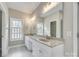 Bathroom featuring dual sinks with white cabinetry, a large mirror, and natural light from the window at 111 Sterling Dr, York, SC 29745