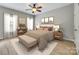 Well-lit bedroom with a neutral color scheme, hardwood floors, bench, and decor at 111 Sterling Dr, York, SC 29745
