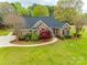 Beautiful exterior elevation of the home, featuring a brick facade, manicured lawn, and a black roof at 111 Sterling Dr, York, SC 29745
