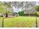 Beautiful exterior shot of a home with a well-manicured lawn, mature trees, and a deck at 111 Sterling Dr, York, SC 29745