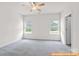 Spacious carpeted bedroom with two windows and natural light at 6025 Jasmine Branch Rd, Charlotte, NC 28216