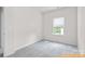 Carpeted bedroom with a window providing natural light at 6025 Jasmine Branch Rd, Charlotte, NC 28216