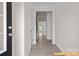 Hallway with luxury vinyl flooring, white trim, and view into the living area at 6025 Jasmine Branch Rd, Charlotte, NC 28216