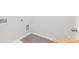 The laundry room is shown with washer-dryer hookups and gray wood-style flooring at 6025 Jasmine Branch Rd, Charlotte, NC 28216