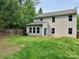Backyard featuring a large grassy lawn and privacy fence at 12815 Towering Pine Dr, Charlotte, NC 28269