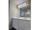 Bathroom vanity featuring double sinks, white cabinets, large mirror, and modern lighting at 12815 Towering Pine Dr, Charlotte, NC 28269