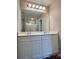 Bathroom vanity featuring double sinks, white cabinets, large mirror, and modern lighting at 12815 Towering Pine Dr, Charlotte, NC 28269