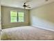 Bright bedroom with plush carpet, neutral walls, and several windows at 12815 Towering Pine Dr, Charlotte, NC 28269