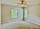 This bedroom features large window views and a ceiling fan at 12815 Towering Pine Dr, Charlotte, NC 28269