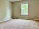 Bright bedroom with plush carpet and a large window offering lots of natural light at 12815 Towering Pine Dr, Charlotte, NC 28269