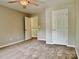 This bedroom features plush carpeting and convenient access to other rooms at 12815 Towering Pine Dr, Charlotte, NC 28269