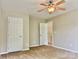 Bedroom with plush carpet, neutral walls, and doorways to adjoining spaces at 12815 Towering Pine Dr, Charlotte, NC 28269