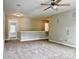 Open bonus room with neutral walls, carpet flooring, and ceiling fan at 12815 Towering Pine Dr, Charlotte, NC 28269