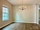 Formal dining room with modern flooring, chandelier lighting, and a window for natural light at 12815 Towering Pine Dr, Charlotte, NC 28269