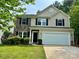 Charming two-story home featuring a two-car garage, stone accents, and a well-maintained front yard at 12815 Towering Pine Dr, Charlotte, NC 28269