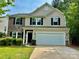 Charming two-story home featuring a two-car garage, stone accents, and a well-maintained front yard at 12815 Towering Pine Dr, Charlotte, NC 28269