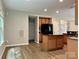 Bright kitchen with kitchen island, wood cabinets, and stainless steel appliances at 12815 Towering Pine Dr, Charlotte, NC 28269