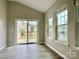 Bright living room featuring sliding glass doors, natural light, and wood-look flooring at 12815 Towering Pine Dr, Charlotte, NC 28269