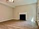 Cozy living room with a fireplace, modern flooring, and a ceiling fan for a comfortable and inviting atmosphere at 12815 Towering Pine Dr, Charlotte, NC 28269