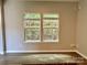 Bright living room featuring windows, natural light, and wood-look flooring at 12815 Towering Pine Dr, Charlotte, NC 28269